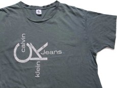 画像1: 90s USA製 Calvin Klein Jeans カルバンクライン ロゴ ひび割れプリント ペンキ飛び コットンTシャツ グリーングレー XL (1)